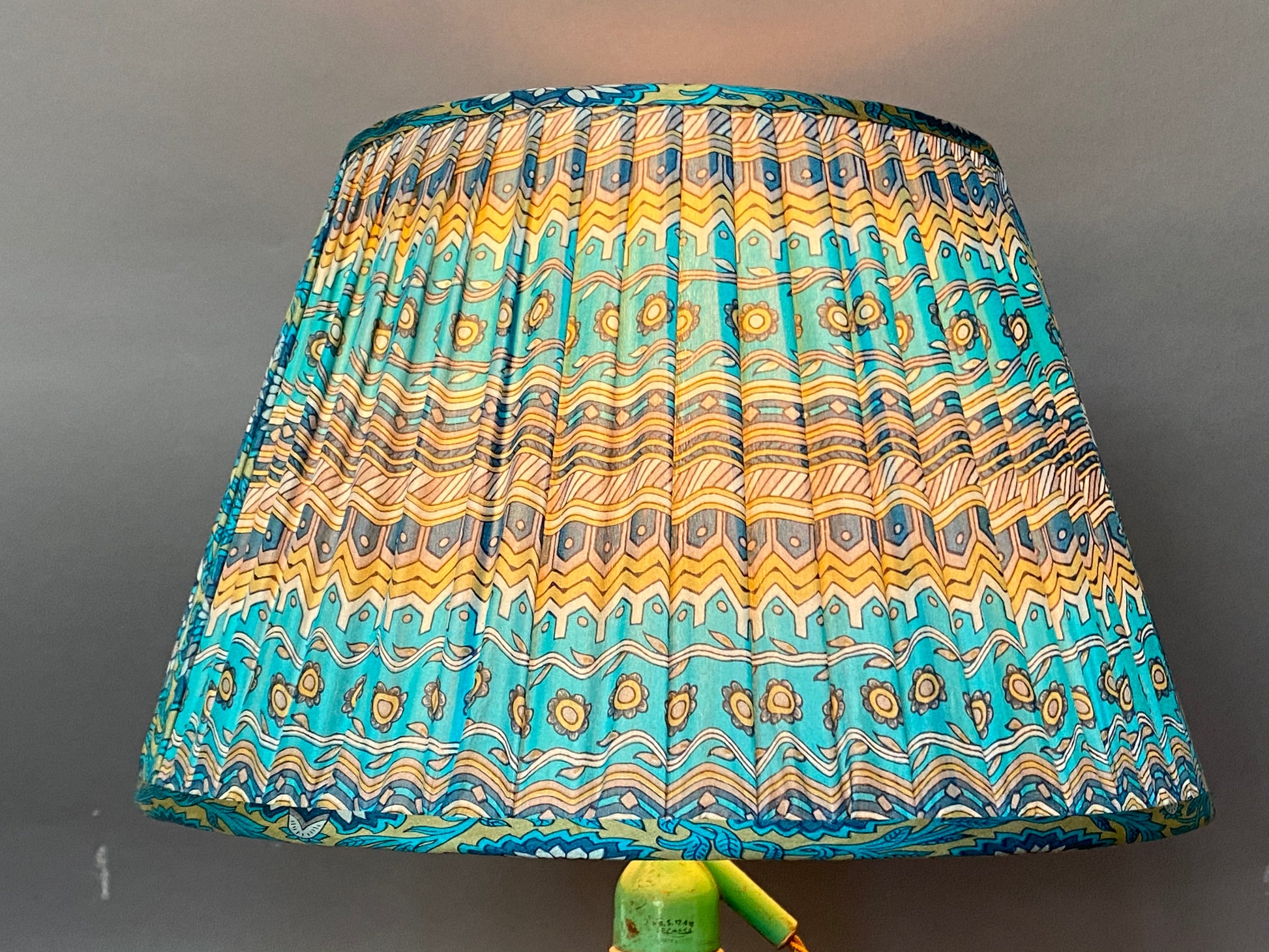 Azure and stone paisley with pallu silk Lampshade with light bulb on