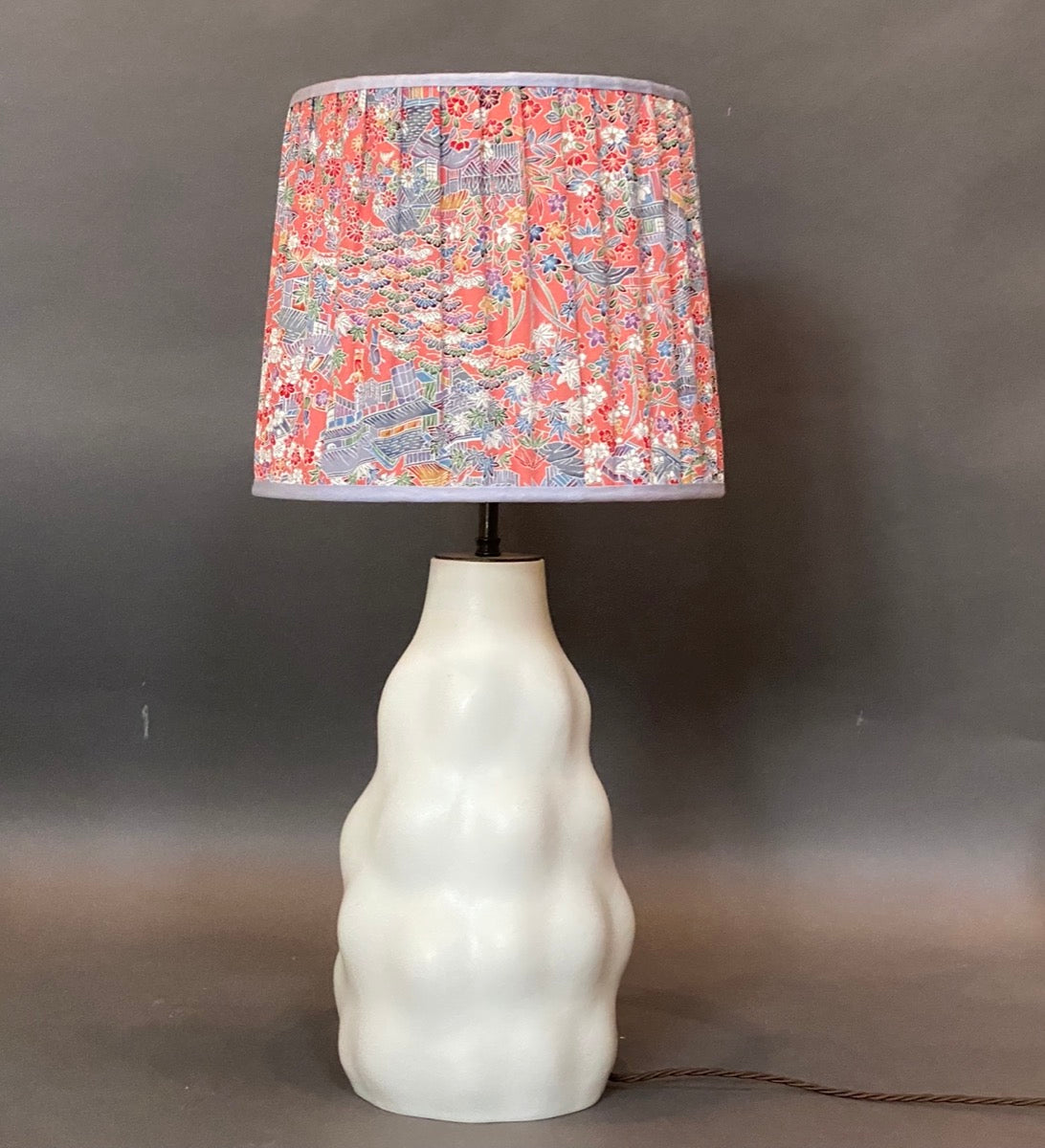 Raspberry and blue patterned silk kimono Lampshade shown on a ceramic 'Iki' lamp base on a grey background
