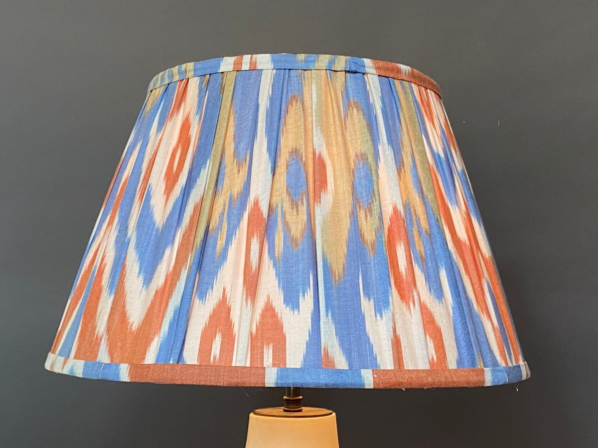 blue orange and yellow ikat lampshade lit