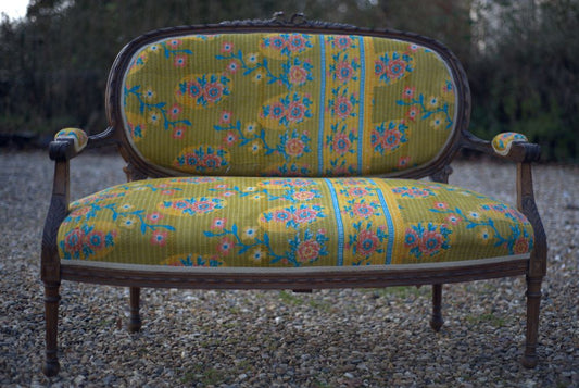 19th century yellow french sofa outdoors